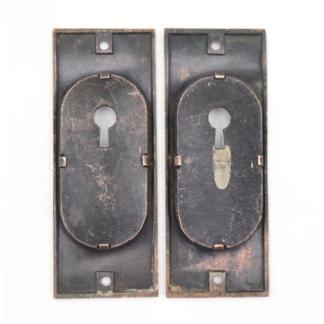 Antique Eastlake style recessed pocket door pulls made of bronze with a patina finish. The original mounting screws are...
