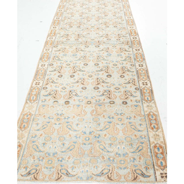 A captivating example of early 20th-century Persian textile artistry, this antique Tabriz runner fragment exemplifies the...