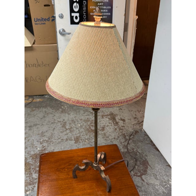 Design Plus Gallery presents a Vintage Rustic Wrought Iron Table Lamp. The lamp pairs a slender wrought iron stem with a...