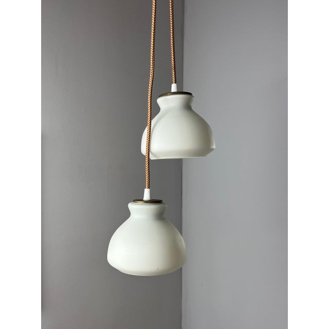 This small pendant lamp is an elegant example of timeless lighting design, achieving a harmonious balance between cool and...