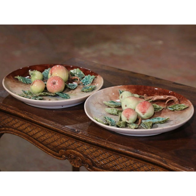 Decorate a kitchen wall or a breakfast room with this large pair of antique majolica plates. Sculpted in France circa 1880...