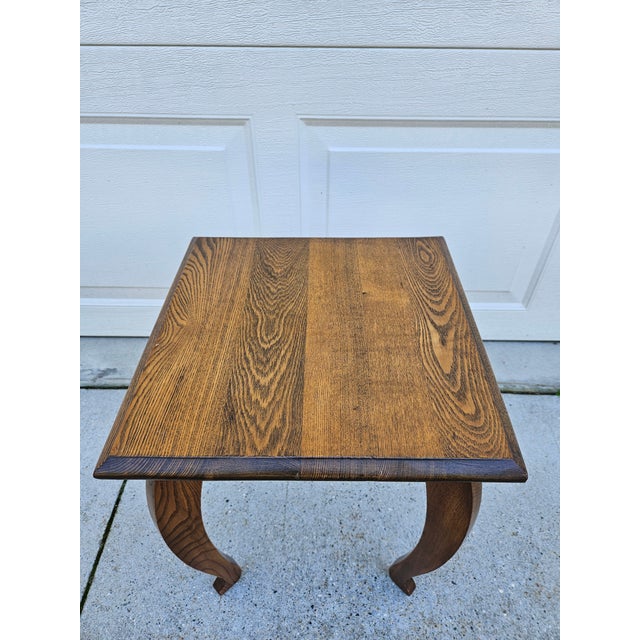 A vintage, possibly antique oak plant stand or small side table. This piece features warm oak woodgrain and slender...