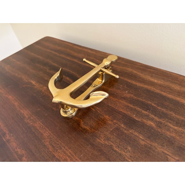 A handsome late-20th-century cast brass door knocker modeled as a traditional ship’s anchor. The clean, graphic silhouette...
