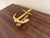 A handsome late-20th-century cast brass door knocker modeled as a traditional ship’s anchor. The clean, graphic silhouette...