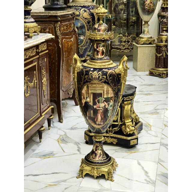 Elegant pair of French porcelain vases, decorated with a multicolored background and delicate galant scenes in reserve....