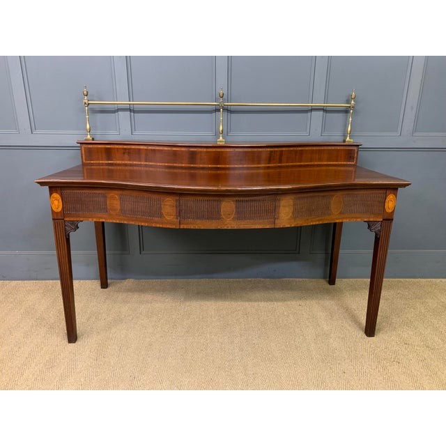 An excellent George III period inlaid mahogany serving table, or server. Of generous proportions and of bold serpentine...