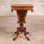 This 20th Century English Central Pedestal Sewing Table is a graceful antique that reflects the practical elegance of...