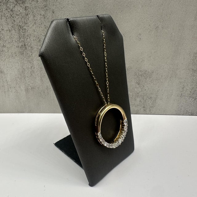 This elegant diamond circle necklace in 14kt yellow gold features approximately 1 carat total weight of natural GH SI2–I1...