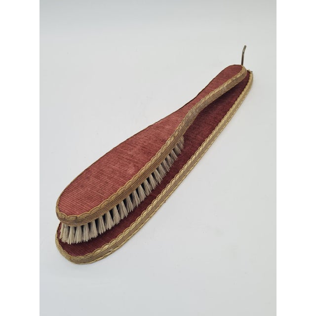 An elegant, vintage-style clothing care set consisting of a lint brush and a matching case. The set is finished with a...