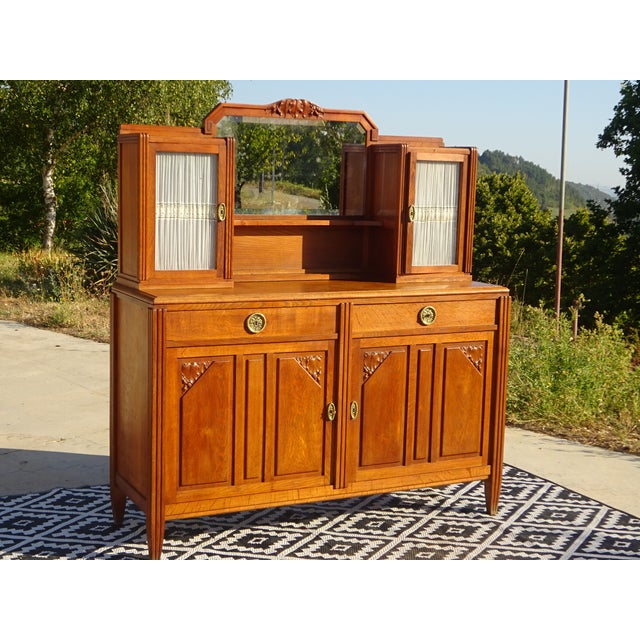 Sideboard with 2 doors and 2 drawers topped with two sentry boxes framing a mirror. Glass-fronted cabinets with pendant...
