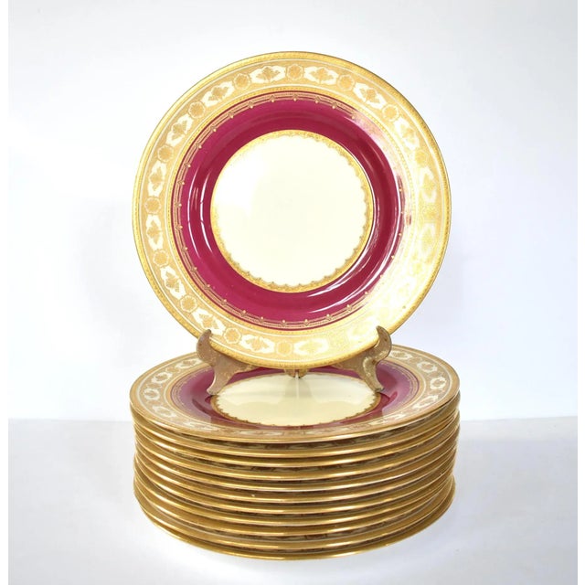 A set of 12 vintage, early to mid-20th-century English dinner plates by Mintons, in an ornate design of magenta or fuschia...