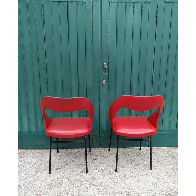 Pair of vintage armchairs, circa 1970. Red vinyl seats, black metal legs. In very good condition, with some minor stains...
