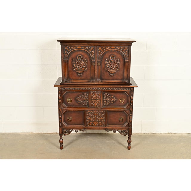 A beautiful antique English Jacobean or Tudor style highboy dresser or gentleman's chest In the manner of Berkey & Gay By...