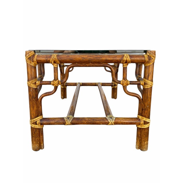Offered here is a McGuire Furniture faux bamboo rattan coffee table or side table. It features glass table top with...