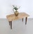 Made in Italy, 1950s. This coffee table features a beech frame with brass feet caps and a pink travertine top. Its design...