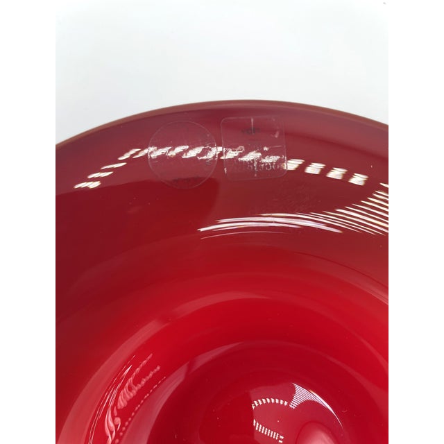 A venini vase from the anni thirties series in red. it is a blown glass piece made in 1984, as can be seen from the...