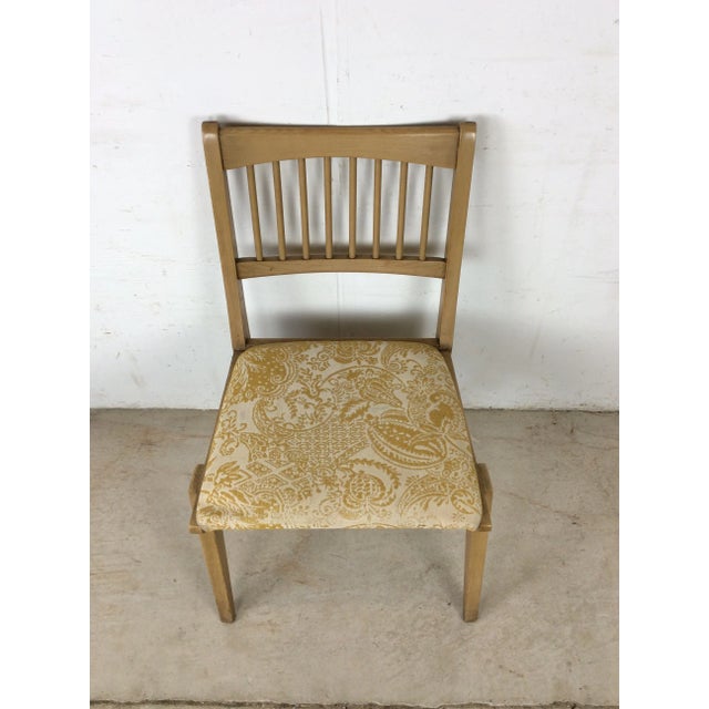 This mid century modern side chair features hardwood construction, original limed oak finish, newer patterned upholstery,...