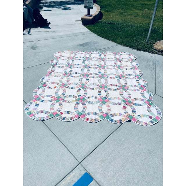 Antique American quilt done in the ever popular pattern of the Double Wedding Ring. Circa is 1930’s, and the quilt is...