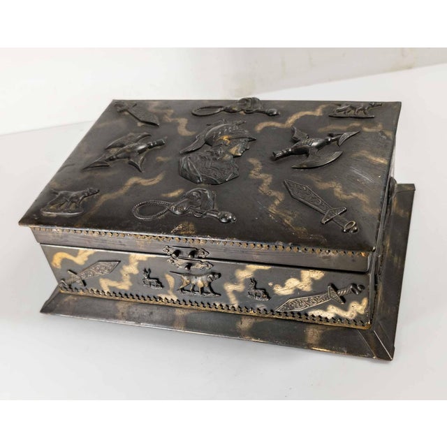 We are selling this interesting Metal jewelry box. This metal box is decorated with applique featuring Arms and Dogs with...