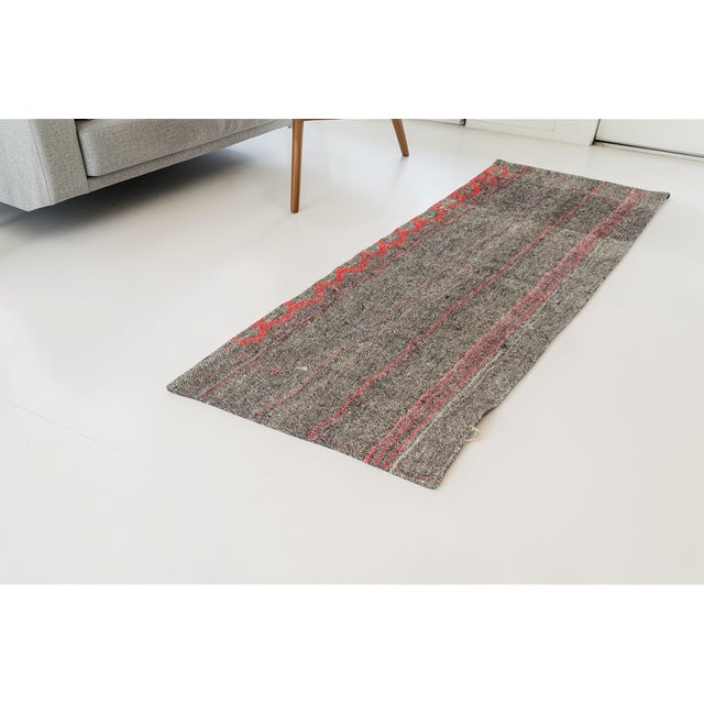 This is a vintage Turkish Oushak rug from the Mid 20th Century. The piece was hand-knotted.