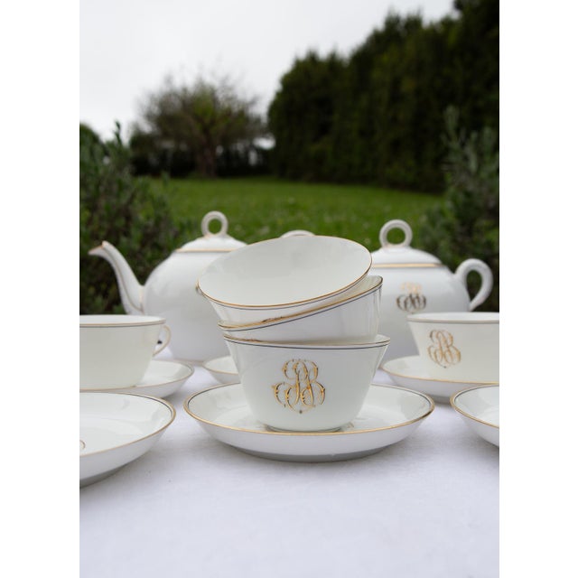 Antique French white porcelain tea set with fine gold details, dating from the late 19th century. The initials P.B. are...
