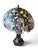 A striking Tiffany-style table lamp featuring an elaborate stained floral shade supported by a beautifully sculpted female...