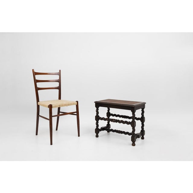 This charming antique stool from France, circa late 19th century, combines rustic elegance with refined craftsmanship....
