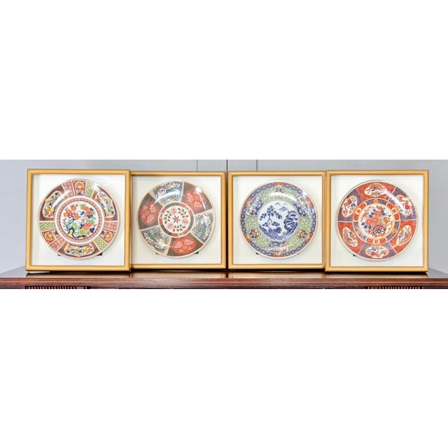 Mid-century Japanese Imari-style porcelain wall plaques, set of four, each mounted in a gold-tone shadowbox frame and...