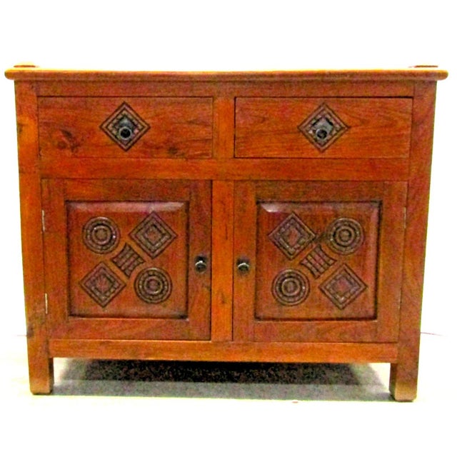 This Antique Dutch Colonial Teak Carved Two Drawer Two Door Buffet Cabinet is a beautifully crafted piece of furniture...