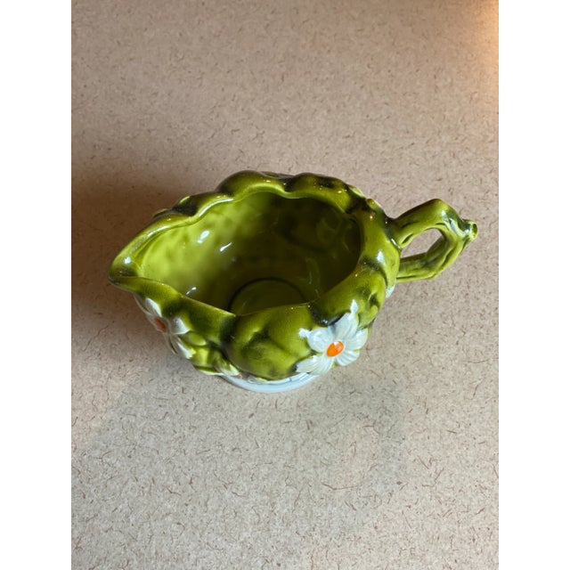 A charming creamer, boasting the Green Apples and Daisies design in Inarco’s fruit-centric line of ceramics. The handle of...