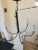 6 Light Iron Chandelier in Iron Oxide finish with whit metal candle covers. This Chandelier is suitable for a transitional...