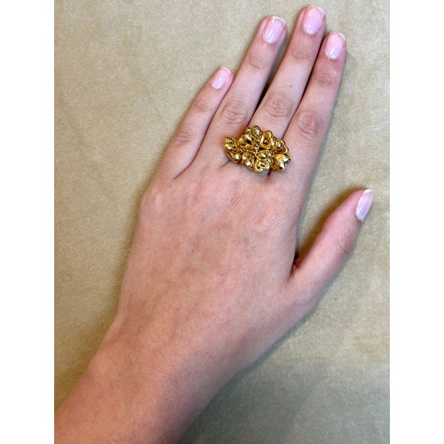This 14 karat yellow gold ring features close to 20 different heart charms, all with unique shapes and bunched together on...