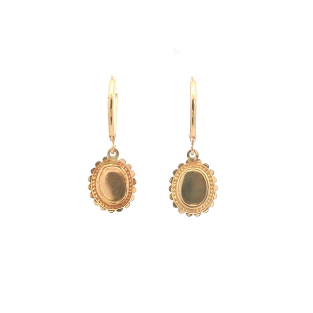 A vintage pair of 14k gold dangle earrings featuring carnelian stones. The stones are cabochon cut. The earrings have...
