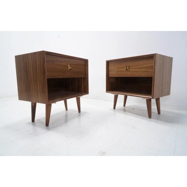 A classic mid century style pair of walnut nightstands with solid brass brasilia pulls, 1 drawer each.Handcrafted of solid...
