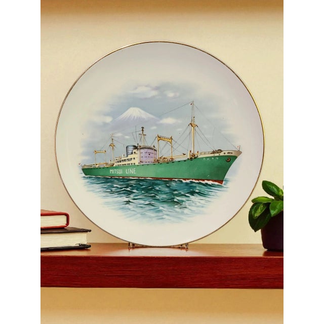 The product is a vintage Japanese Noritake porcelain plate featuring a painted ship from the Mitsui Line. This decorative...