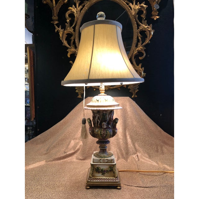 Vintage Hand Painted and Gilt Porcelain Italian Figural Table Lamp. Wonderful scale and dimensions. 2 light sockets with...
