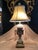Vintage Hand Painted and Gilt Porcelain Italian Figural Table Lamp. Wonderful scale and dimensions. 2 light sockets with...