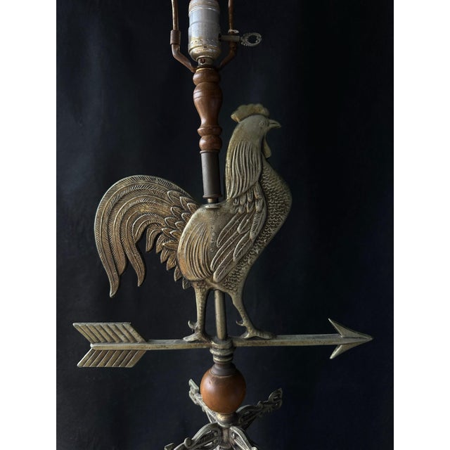 Wonderful vintage brass table lamp featuring a dimensional rooster weathervane with arrow and directional compass details....