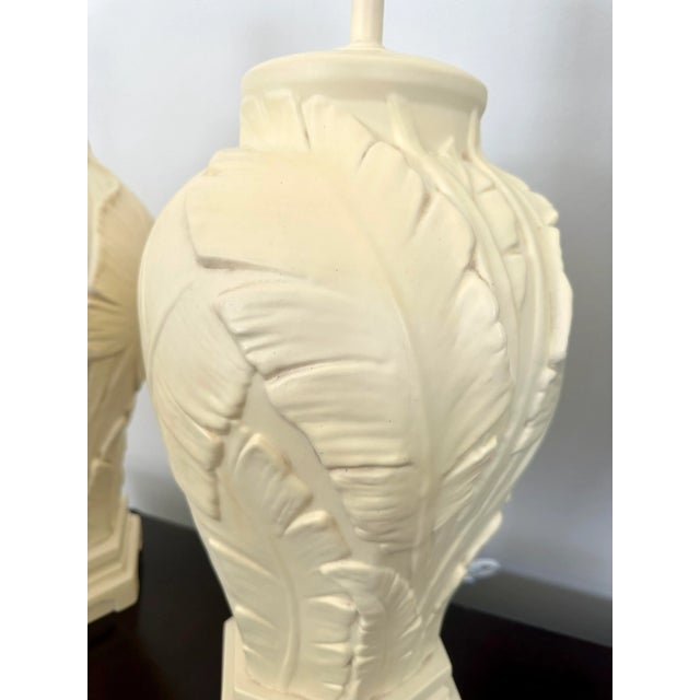Fabulous pair of vintage ceramic palm leaf lamps. The lamps have a hexagon base with a beautiful detailed design on all...
