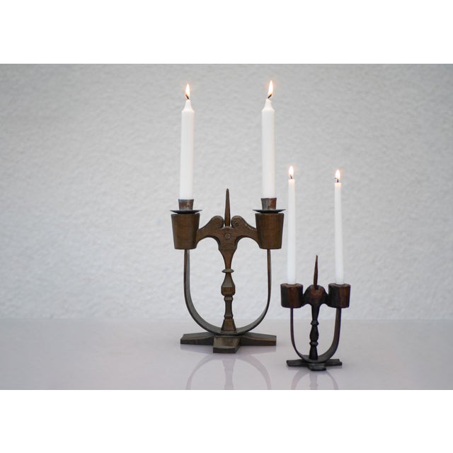 A beautifully matched pair of traditional Swedish handcrafted two-armed wooden candlesticks, known as “Taserudsstaken,”...