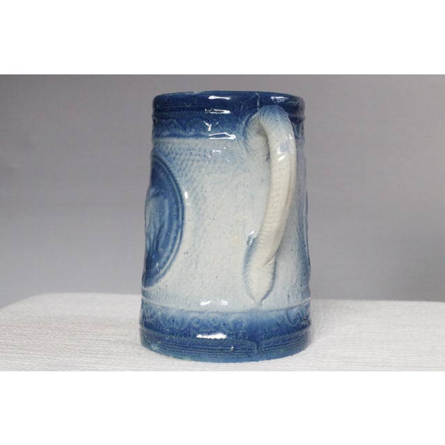 Charming blue and white antique American stoneware milk pitcher from the 1800s. It features classic Victorian embossed and...