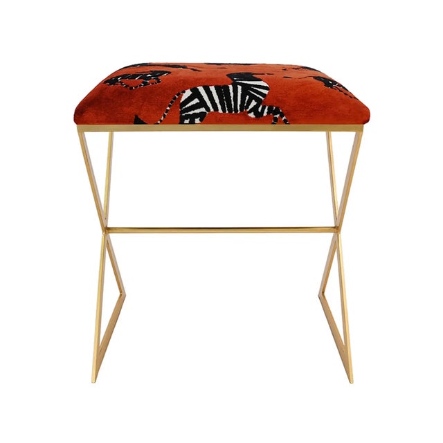 X marks the spot for style! The X Side stool, with its gold leaf frame and cushion in lux poppy colored zebra upholstery...