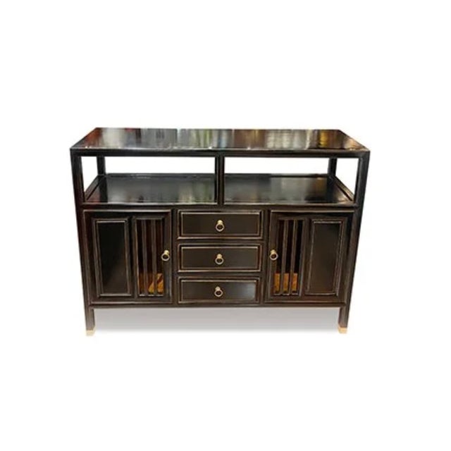 Western Lacquer Stand Sideboard is made out of elm wood. It has 3 drawers and 2 doors with an orange trimming around the...