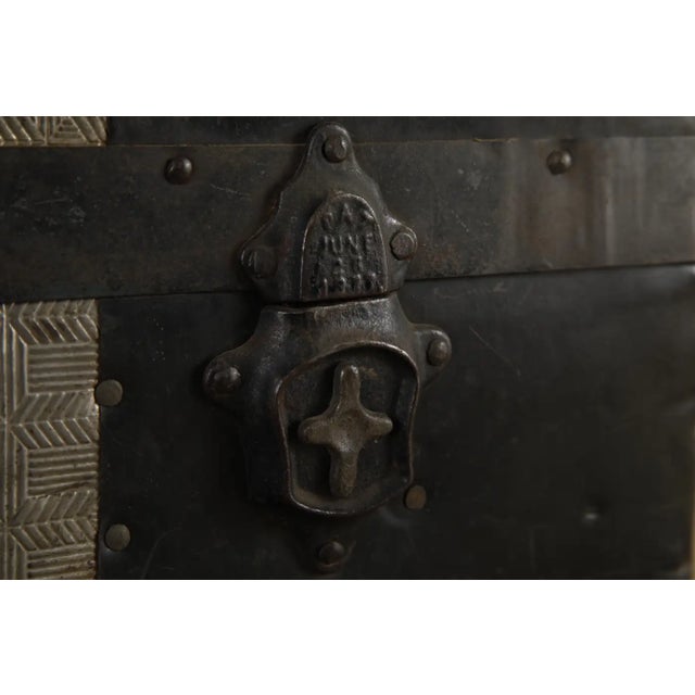 A striking example of late 19th century American luggage craftsmanship, this antique steamer trunk features embossed zinc-...