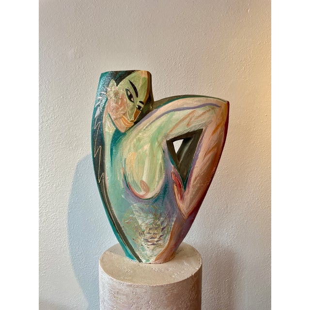 This cubist-style double-sided painted ceramic vase by Santa Fe artist Gretchen Wachs features abstract female facial...