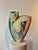 This cubist-style double-sided painted ceramic vase by Santa Fe artist Gretchen Wachs features abstract female facial...