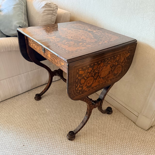 Inlaid Drop-Leaf Table Early 20th century table with two collapsible leaves and one central drawer. Age appropriate crack...