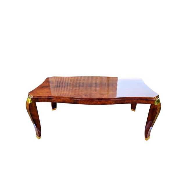 Maurice Rinck in Paris Art Deco dining table, circa 1930-40 Varnished blond violet wood and gilt bronze The undulating top...