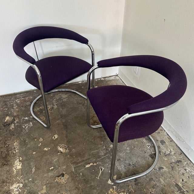 Stunning pair of bent tubular chairs made by Thonet Industries. The chairs feature heavy chromed steel and original high...