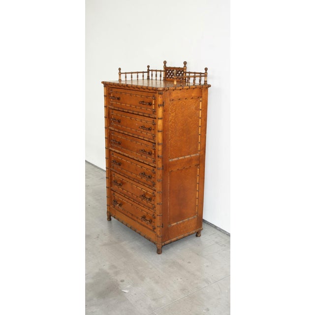 A handsome late 19th century Wellington chest by Paine Furniture Company, crafted in richly figured birdseye maple with...